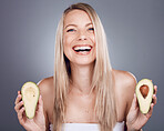Portrait, beauty and avocado with a model woman in studio on a gray background for natural treatment. Face, skincare and nutrition with an attractive young female posing to promote skin antioxidants
