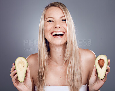 Buy stock photo Portrait, beauty and avocado with a model woman in studio on a gray background for natural treatment. Face, skincare and nutrition with an attractive young female posing to promote skin antioxidants