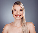 Portrait, beauty and hair with a model woman in studio on a gray background for keratin treatment or natural haircare. Face, skincare and wellness with a female posing to promote a haircare product