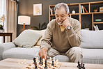 Senior man, thinking or playing chess in house, home living room or apartment in Japanese strategy, checkmate or board game contest. Retirement elderly, smart person or chessboard challenge for mind