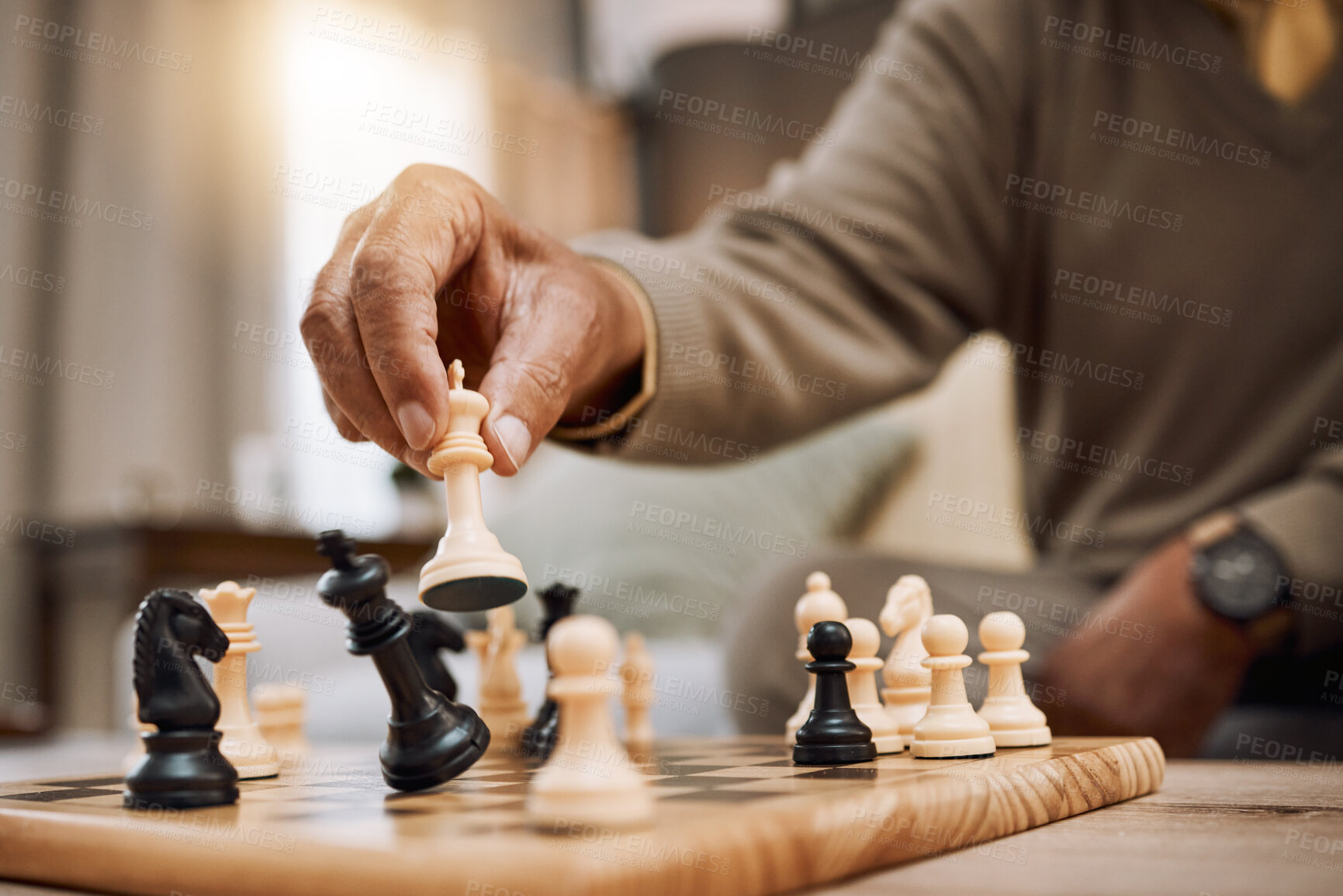 Buy stock photo Man, playing hands and chess king in house, home living room or apartment in winner strategy, checkmate or board game success. Zoom, chessboard and winning pawn in thinking mind challenge or activity