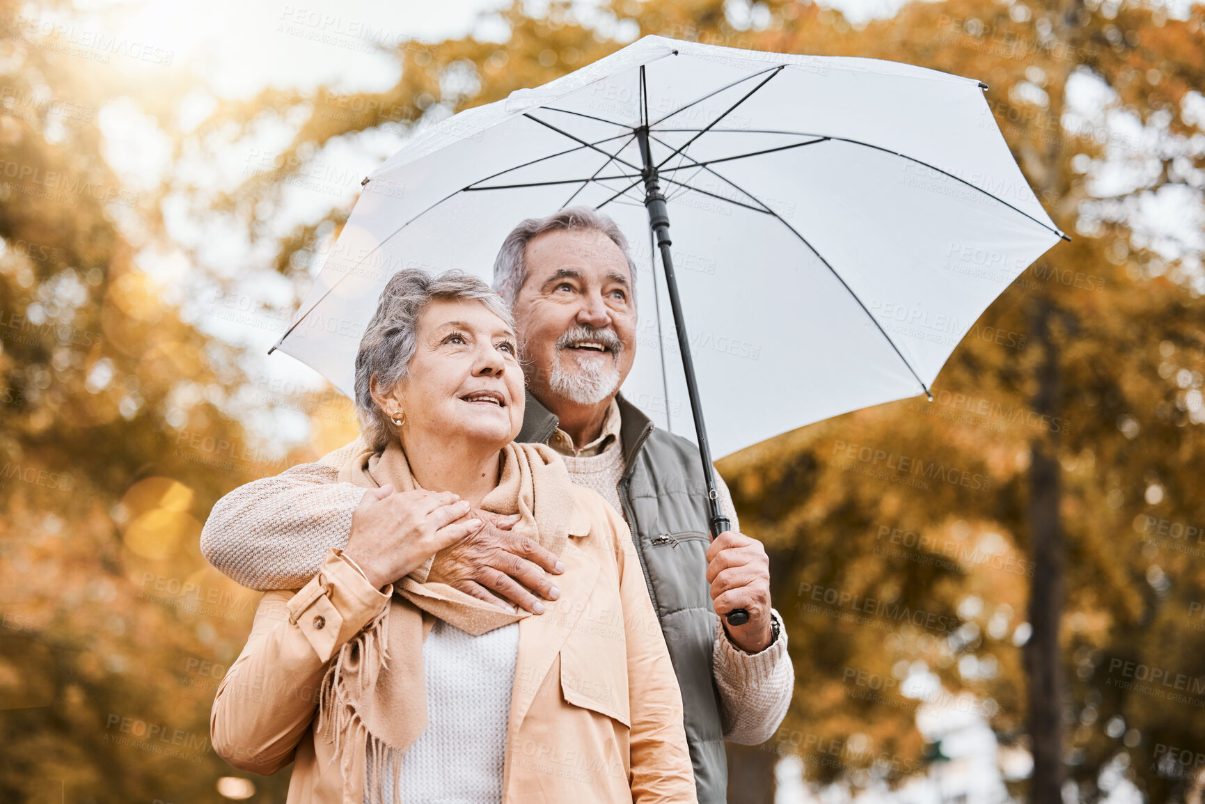 Buy stock photo Senior couple, umbrella and walking outdoor for relax freedom, calm quality time and relationship bonding in summer. Elderly man, woman and wellness walk in countryside park together for love or care