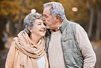Love, kiss and senior couple in park enjoying weekend, quality time and romantic bonding together. Retirement, relationship and elderly man and woman walking, hugging and embrace outdoors in nature
