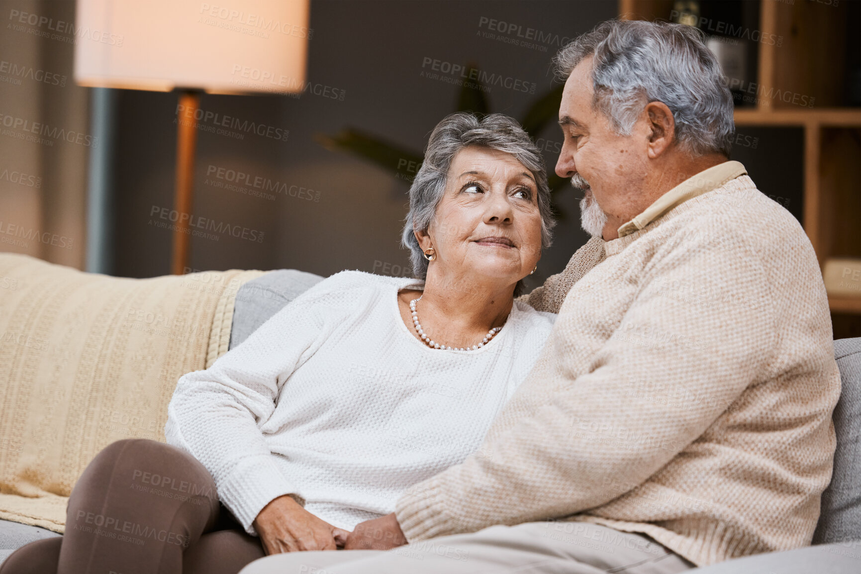 Buy stock photo Love, sofa and senior couple talking, marriage and bonding for relationship, retirement and romance. Romantic, elderly man and mature woman in living room, conversation and relax on weekend break.