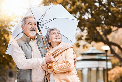 Buy stock photo Senior couple, umbrella and walking outdoor for relax freedom, calm quality time and relationship bonding in summer. Elderly man, woman and wellness walk in countryside park together for love or care