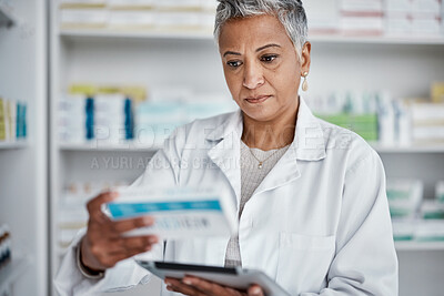 Buy stock photo Pharmacist woman, tablet and reading box for information, stock or wellness in store with focus. Senior pharma expert, digital tech and stock in pharmacy for medicine, health or online help in Mumbai