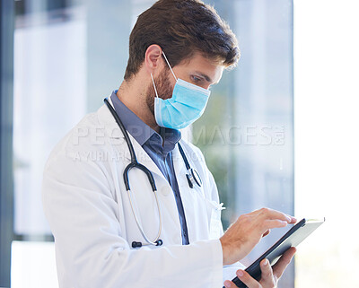 Buy stock photo Digital tablet, face mask and doctor doing research on covid, healthcare or pandemic in a hospital. Professional, technology and medical worker analyzing results on a mobile device in medicare clinic