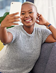 Black woman, selfie and smile on sofa for social media, beauty and happy in home living room. Influencer woman, happiness and relax on couch for social network picture, smartphone and communication