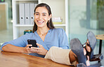 Woman, feet and desk in portrait with smartphone, smile and social media app in workplace. Happy executive leader, office and smartphone for networking, communication or social network in Los Angeles