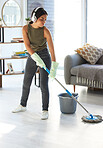 Music, cleaning and mop with woman in living room streaming while housekeeping, sanitary and hygiene. Mobile radio, podcast and listening to headphones with girl cleaner mopping floor for hospitality
