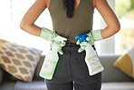 Hands, spray bottle and the back of a woman cleaner in a living room for housekeeping or cleaning. Gloves, home and spring cleaning with a female housekeeper working to clean or wash an apartment