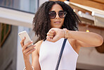 Time, watch and smartphone of woman in city for summer shopping sale, discount or promotion marketing with online website. Black woman outdoor on cellphone waiting for promo on retail, ecommerce app