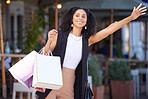 Black woman, shopping and city street as happy customer waves hand for cab or taxi on urban street with retail bags. Travel, fashion and smile of female while waiting for transport outdoor in France