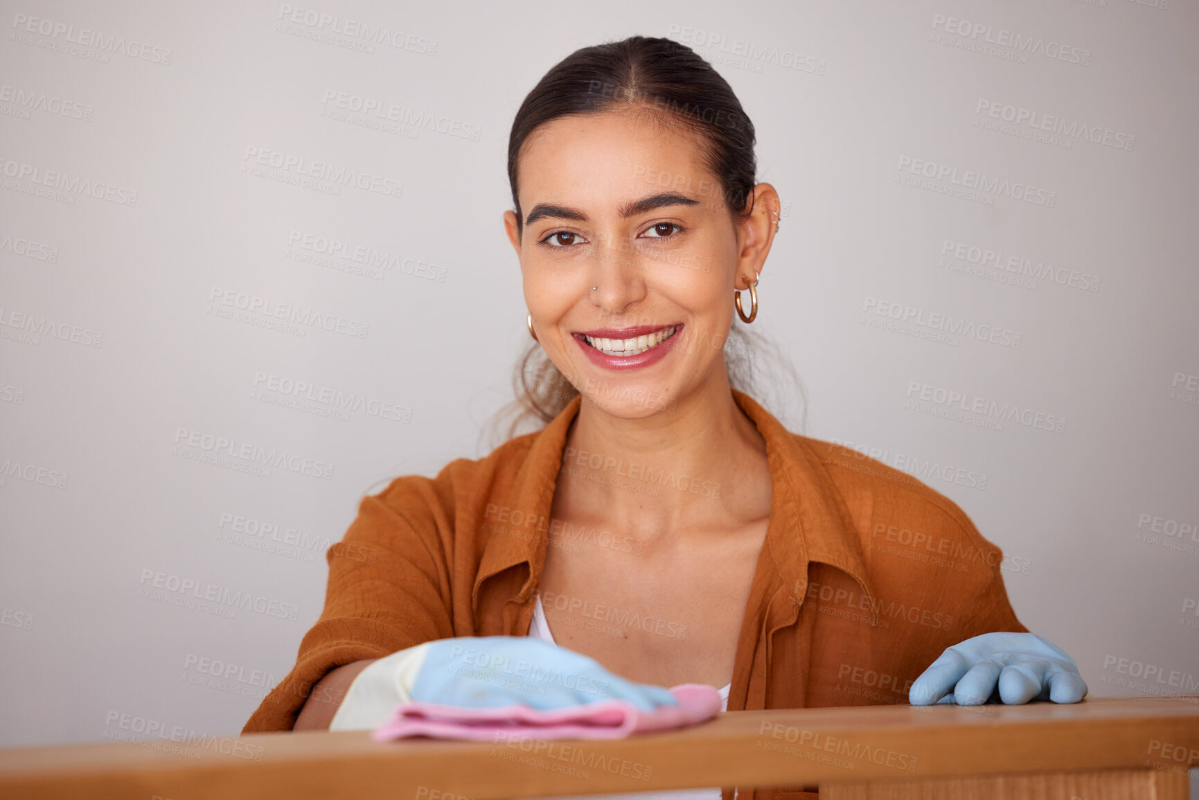 Buy stock photo Portrait, cleaning and wipe with a woman housekeeper or cleaner using a rag cloth to dust furniture. Face, bacteria and dirt with a female working to service a dirty apartment for housekeeping