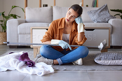 Buy stock photo Tired, sad and woman cleaning home overwhelmed, stressed and moody thinking of tasks. Spring cleaning fatigue of young girl thoughtful in house living room with  cleaner hygiene products