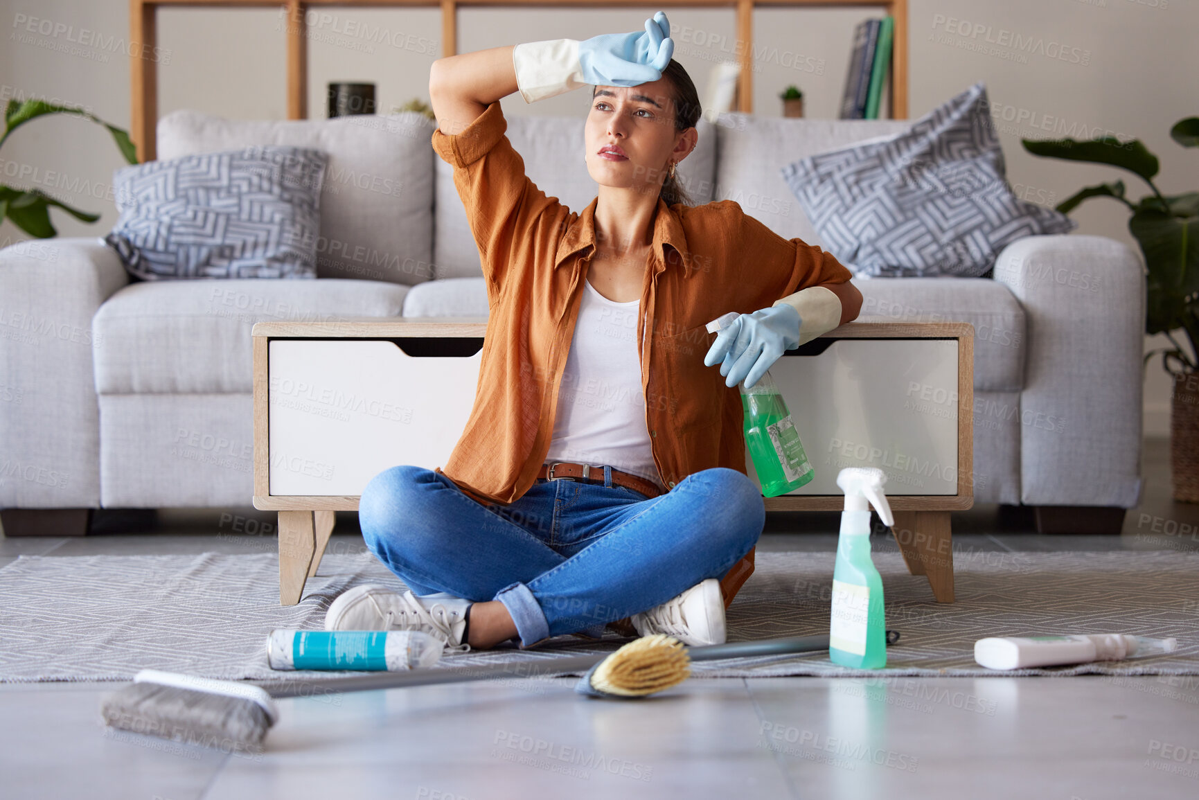 Buy stock photo Tired woman, cleaning and sitting on living room floor with detergent, chemicals or sanitizer spray for hygiene at home. Female domestic worker exhausted from housekeeping, chores or clean house