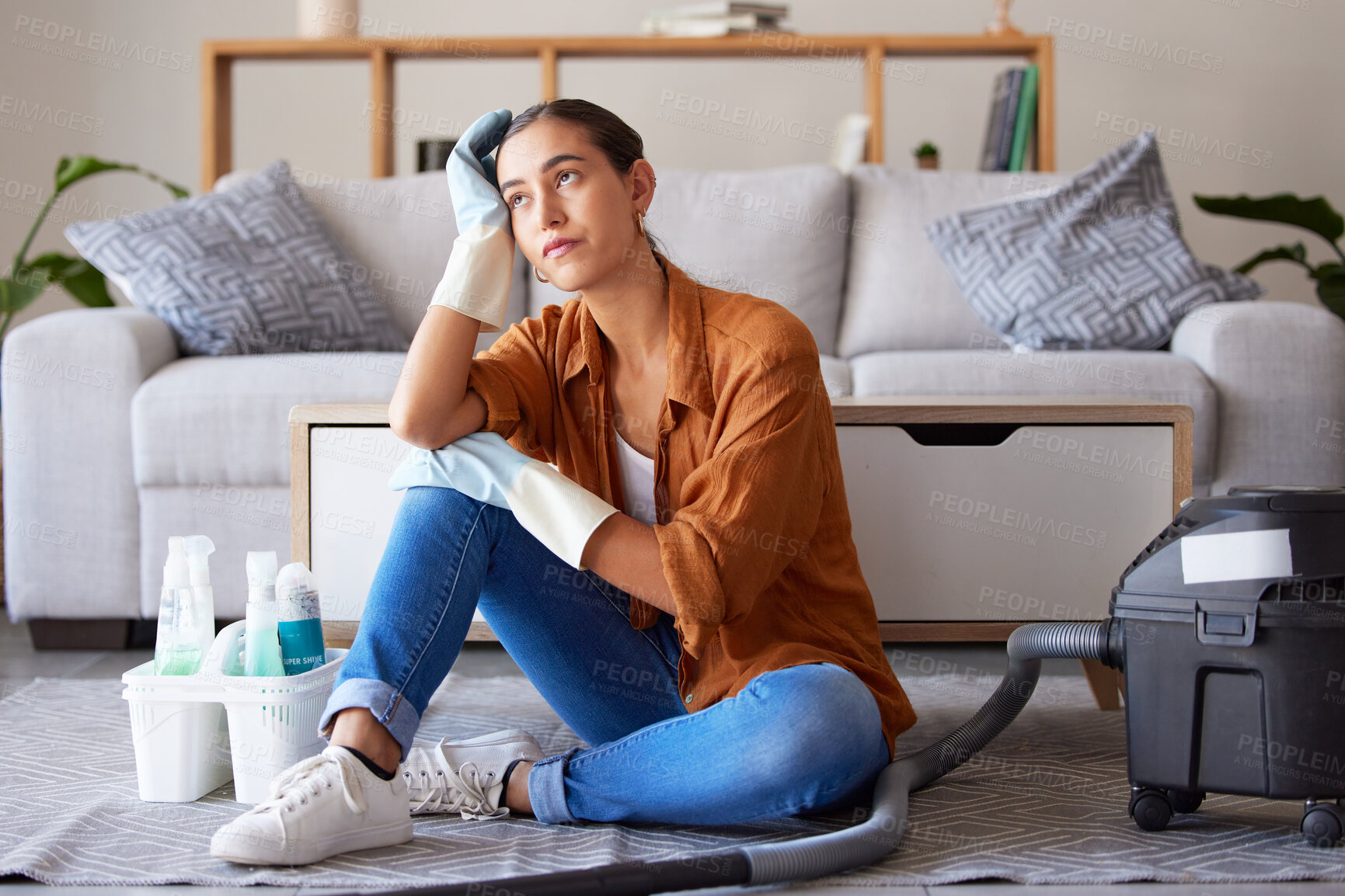 Buy stock photo Tired, sad and woman cleaning home overwhelmed, stressed and moody thinking of tasks. Spring cleaning fatigue of young girl thoughtful in house living room with  cleaner hygiene products