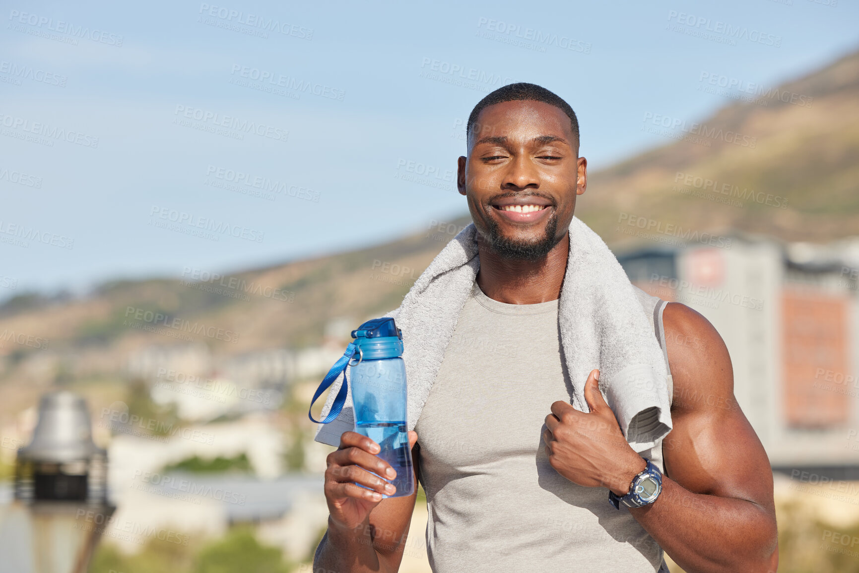 Buy stock photo Portrait, fitness and water bottle with a sports black man or runner standing outdoor with a towel during exercise. Training, running and workout with a young male athlete outside for cardio