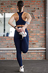 Woman, legs and stretching in fitness gym for workout, training and exercise muscle pain, tension release and body healthcare wellness. Sports athlete, personal trainer and coach in warm up routine