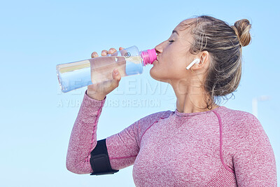 Buy stock photo Woman runner, water bottle and music with earphones for focus, workout and outdoor training for health. Girl, wellness and hydration for running, exercise or streaming audio in summer for strong body