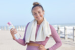 Face, beach and woman with water bottle for drinking water after running, workout or exercise training. Sports, portrait and female from Canada with liquid for hydration streaming music on earphones.