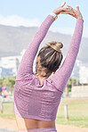 Fitness, exercise and woman stretching outdoor in summer in a city for health, wellness and a healthy body. Back of a sports female or runner ready for cardio training, workout and morning routine