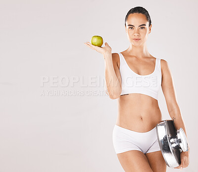 Buy stock photo Fitness, health and woman with scale and apple for weightloss, diet and nutrition on white background. Exercise, wellness and girl with fruit, slim body and weight measurement for healthy lifestyle