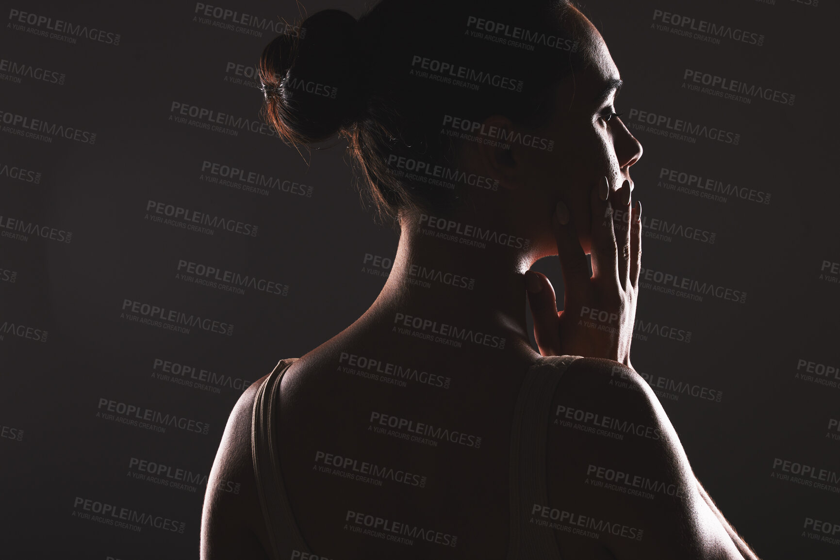 Buy stock photo Creative, beauty and woman silhouette in a studio with a seductive, mysterious or sexy aesthetic. Art, face and profile facial shadow figure of a girl model isolated by a dark black background.