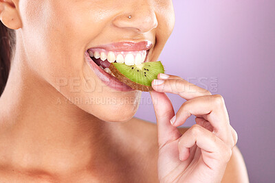 Buy stock photo Woman, face and kiwi for skincare beauty wellness, natural cosmetic health and fruit nutrition diet in purple studio background. Model eating, vitamin c and facial smile for organic skin or body glow