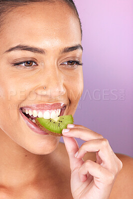 Buy stock photo Woman, face and kiwi for skincare beauty wellness, natural cosmetics health and fruit nutrition diet on purple studio background. Model eating, vitamin c and smile for organic facial skin glow vision