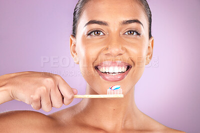 Buy stock photo Woman, smile and toothbrush in studio portrait with self care, beauty and toothpaste for hygiene. Black woman, teeth and cleaning with organic wood brush, happy and self love by purple background