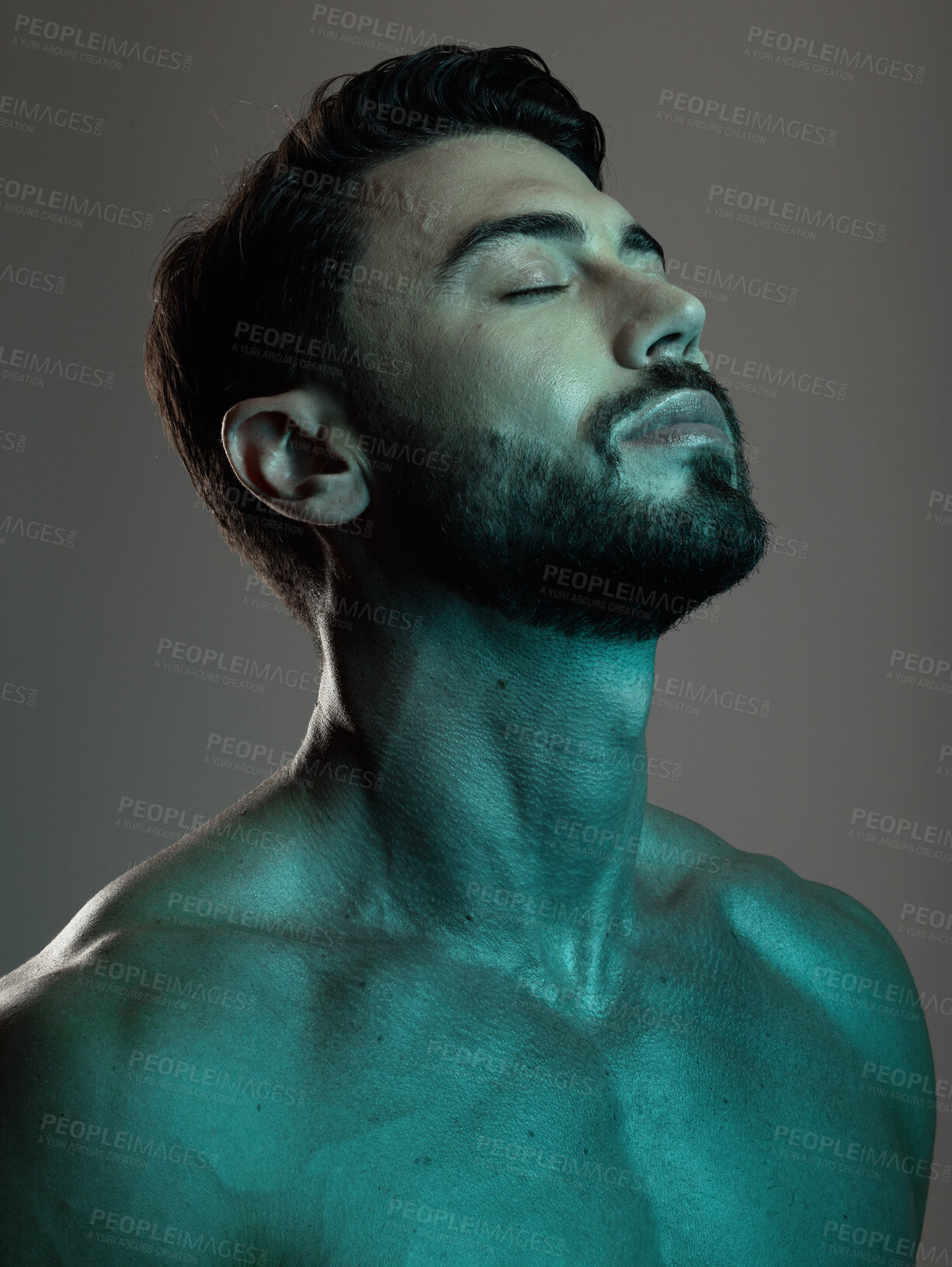 Buy stock photo Man, face and neon with beauty and skincare, grooming and wellness with eyes closed against studio background. Healthy skin, relax in blue light and peace, self care and cosmetic facial and treatment