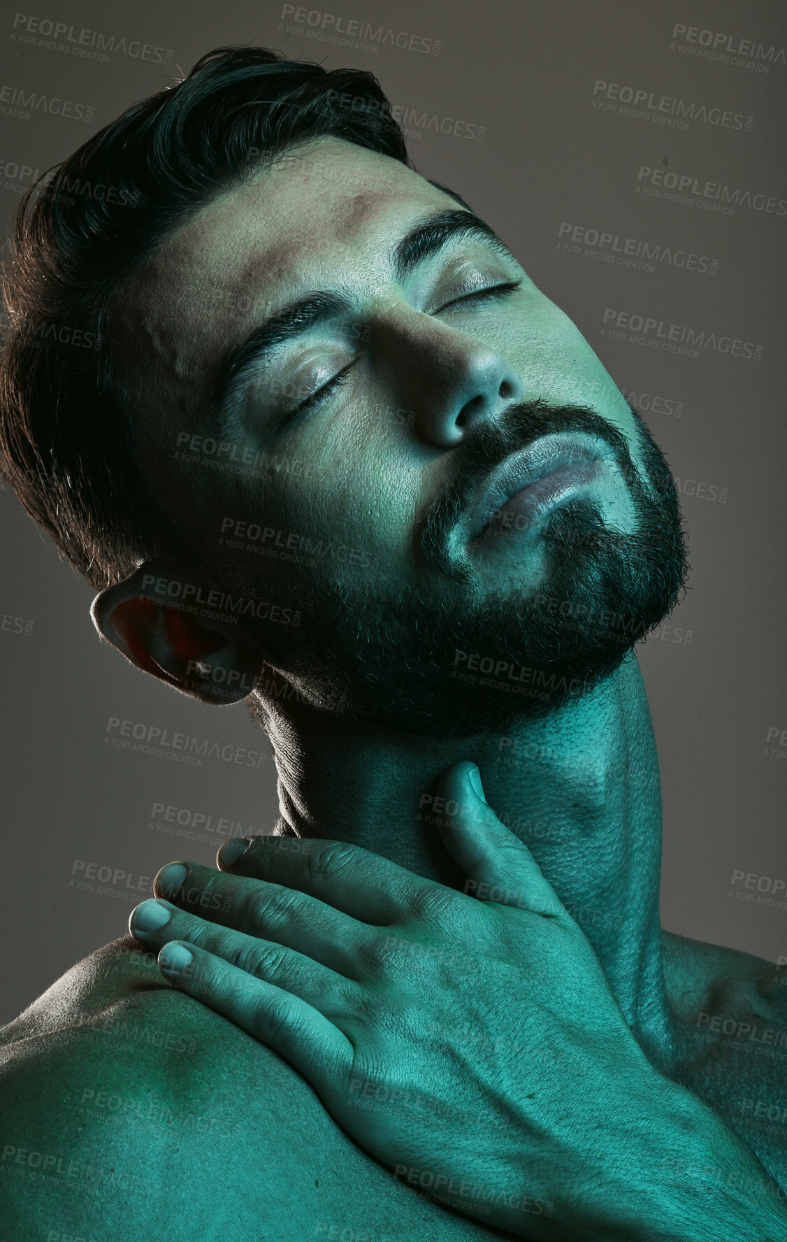 Buy stock photo Man, face and neon with beauty and skincare, grooming and wellness with eyes closed against studio background. Healthy skin, relax in blue light and peace, male and cosmetic facial and treatment