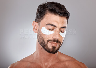 Buy stock photo Skincare, beauty and man with mask for eyes on gray background for wellness, facial treatment and dermatology. Grooming, luxury spa and male with face patch, eye pads and cosmetics products in studio