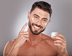Man, skincare and cream in studio portrait with smile, happiness or self care by grey gradient backdrop. Cosmetic model, skin glow or luxury dermatology product in hand for wellness, facial or health