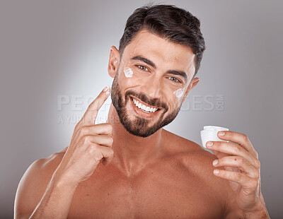 Buy stock photo Man, skincare and cream in studio portrait with smile, happiness or self care by grey gradient backdrop. Cosmetic model, skin glow or luxury dermatology product in hand for wellness, facial or health