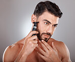 Man, shaving facial beard and razor hair removal, grooming hygiene cleaning or skincare dermatology wellness in grey studio background. Model, face beauty and shave for cosmetics self care cleaning 