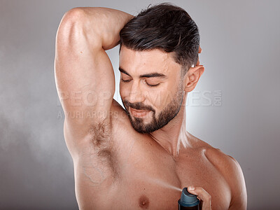 Buy stock photo Spray deodorant and man happy with product for armpit hygiene, grooming and cosmetic campaign. Body care, wellness and skincare model with healthy skin glow in gray studio background.

