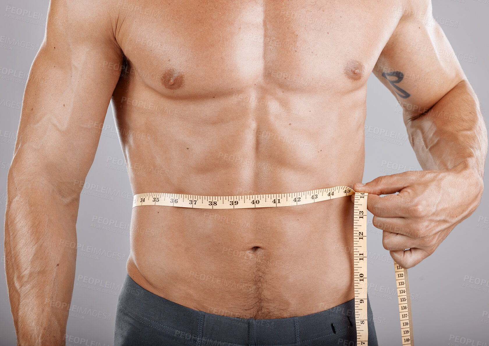 Buy stock photo Man, body and tape measure on abdomen in studio on gray background. Health, fitness and male model with measuring tape for abs to track exercise training results, muscle goals or weight loss target.
