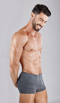 Buy stock photo Fitness, body and man in underwear in a studio for health, wellness and exercise for muscle. Happy, smile and muscular male model from Puerto Rico isolated by a gray background after a workout.