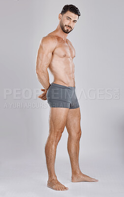 Buy stock photo Portrait, body and a man underwear model in studio on a gray background to promote a brand of drawers. Health, fitness and wellness with a handsome young male posing in underpants for comfort