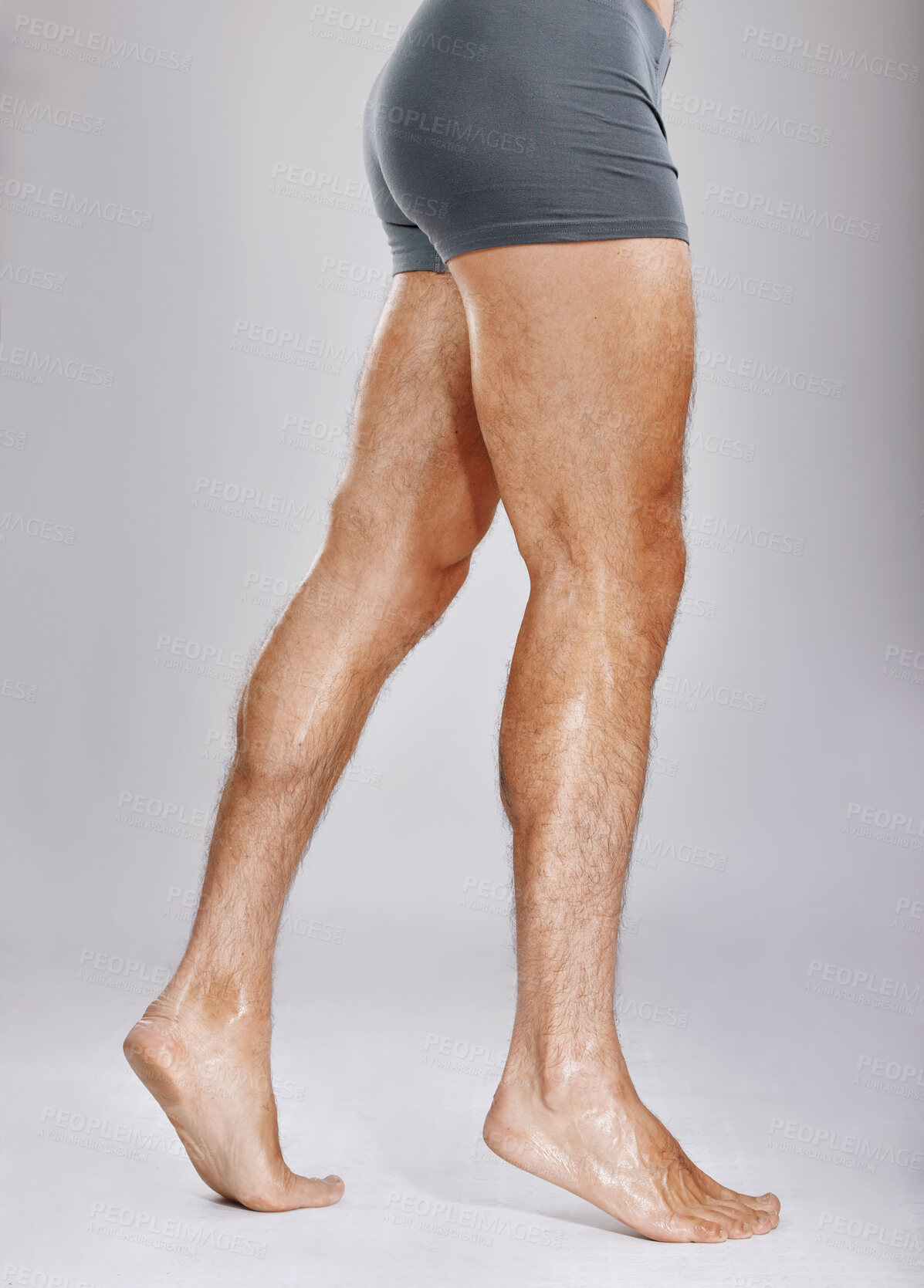 Buy stock photo Man, legs or muscles on studio background for fitness check, workout training goals or studio exercise wellness. Underwear model, bodybuilder and strong athlete feet on gray backdrop for healthcare 