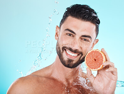 Buy stock photo Skincare, water splash and portrait of man with grapefruit on blue background for vitamin c detox for healthy skin and smile. Fruit, water and facial wellness, spa cleaning and happy male model face.