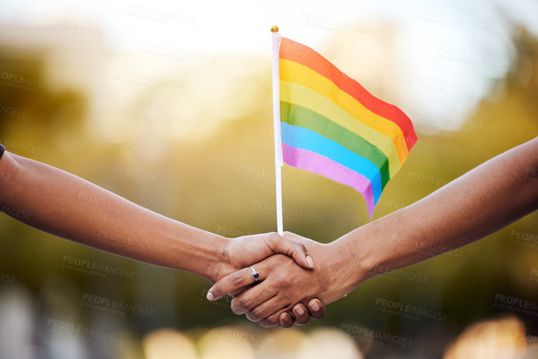 Buy stock photo LGBTQ rainbow, flag and couple holding hands for gay pride, lesbian support or human rights activist. Transgender, love and African black people together for equality, partnership and LGBT community