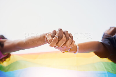 Buy stock photo LGBTQ flag, rainbow and couple holding hands for gay pride, lesbian support or human rights protest. LGBT community, sky and African black people together in love, partnership and equality below view