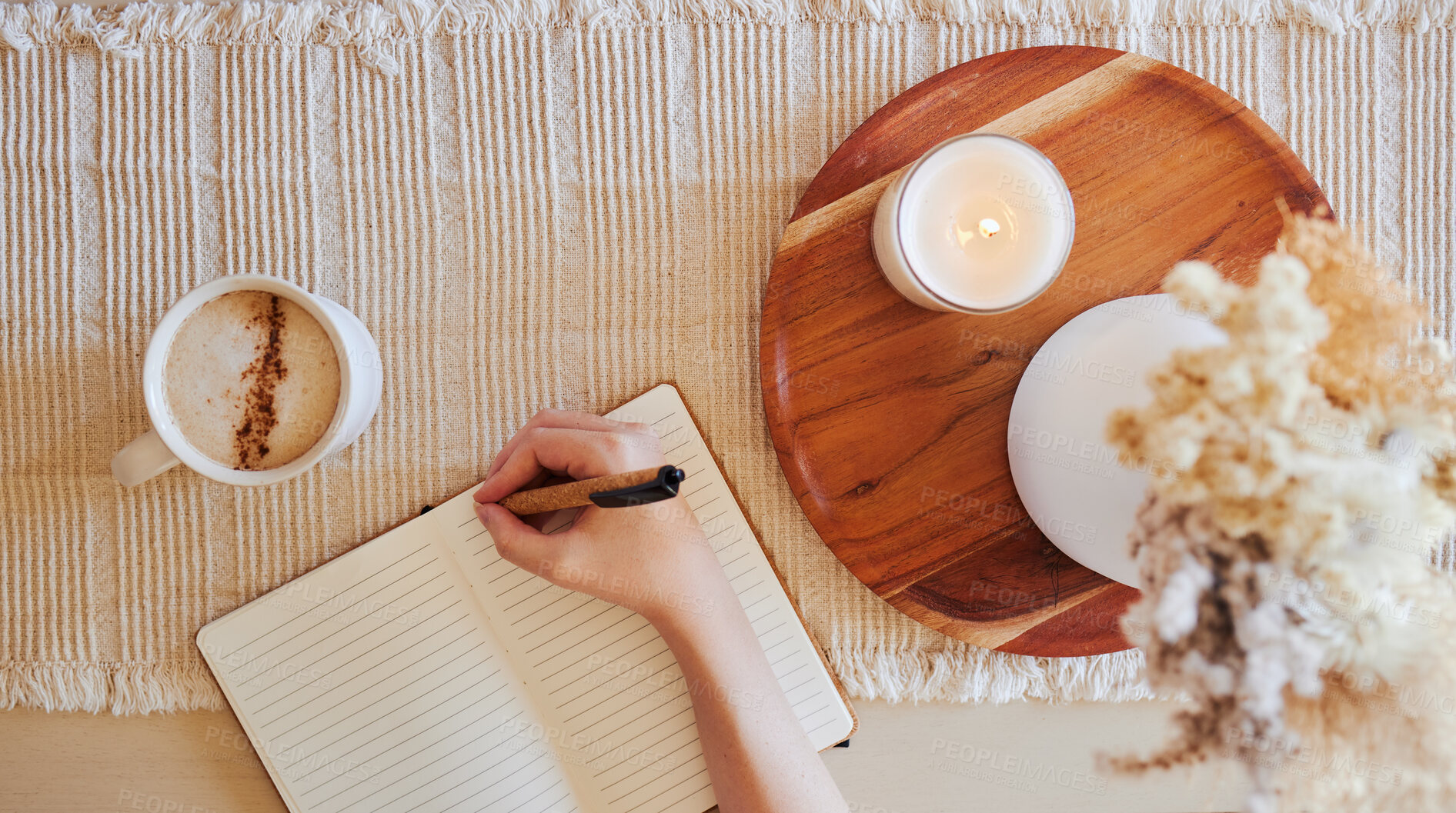 Buy stock photo Coffee, hand and writing in journal top view with candle for calm, peace and relax morning routine. Woman, notebook and diary planning goals, lifestyle motivation or creative writer with warm drink