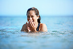 Young woman swimming in ocean, happy on beach vacation and freedom of summer adventure in Mauritius. Female tourist laughing in the water, tropical destination for travel and natural outdoor paradise