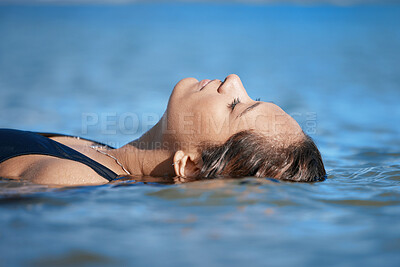 Buy stock photo Woman swimming, travel or fitness in ocean with peace, calm and exercise, wellness and waves at beach. Relax, female swimmer floating and sea with nature, freedom and water sport on summer vacation