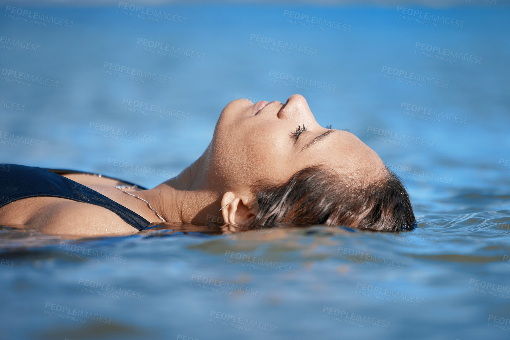 Buy stock photo Woman swimming, travel or fitness in ocean with peace, calm and exercise, wellness and waves at beach. Relax, female swimmer floating and sea with nature, freedom and water sport on summer vacation