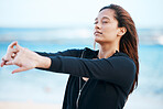 Young woman stretching on beach, relax on summer holiday and peaceful blue sky in Mauritius. Calm female tourist meditating on seaside, healthy outdoor yoga and girl breathing fresh ocean air